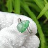 a hand wearing a glove with a ring