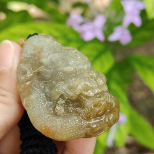 a hand holding a piece of green material