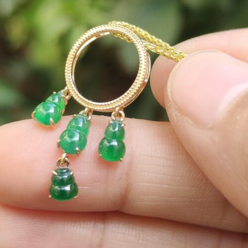 a hand holding a gold necklace