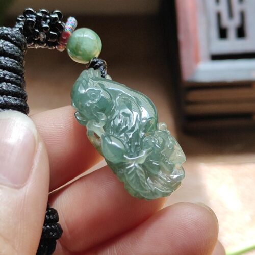 a hand holding a bead