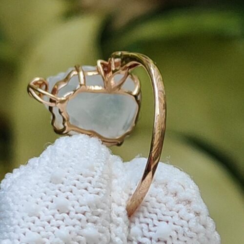 a gold ring on a white cloth