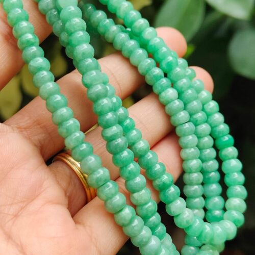 a hand holding a necklace