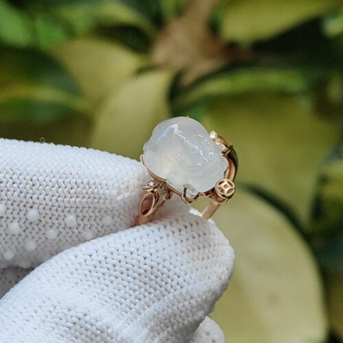 a hand wearing a white glove with a ring on it