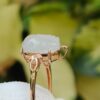 a gold ring with a carved white stone