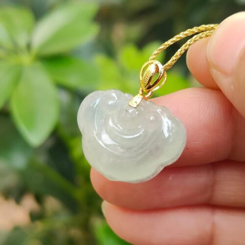 a hand holding a necklace