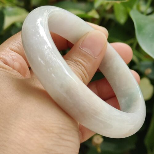 a hand holding a white circular object