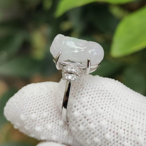 a hand wearing a glove with a white ring with a large stone