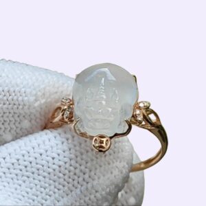 a gold ring with a face on it