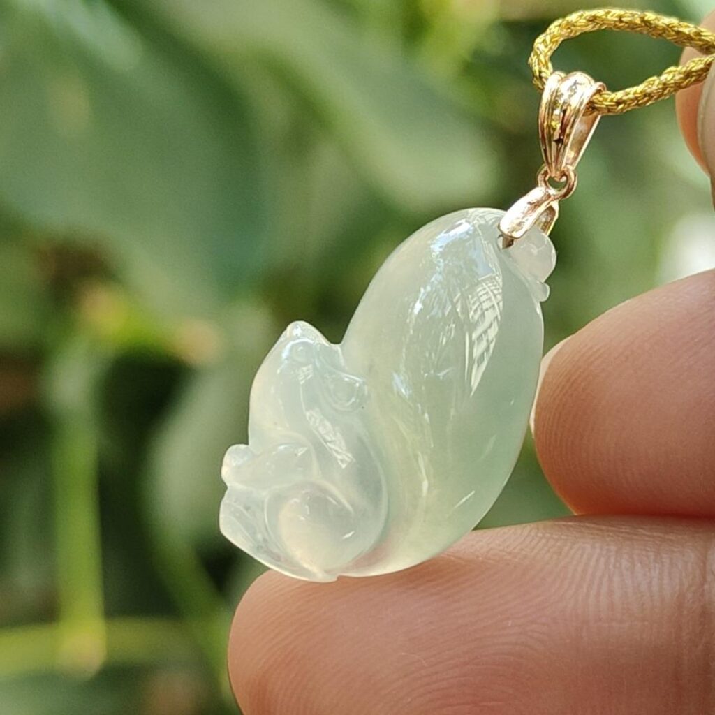 a hand holding a jade pendant - Squirrel Premium Quality with 18k Gold Clasp