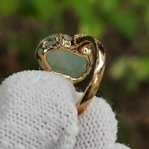 a hand holding a gold ring