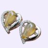 a pair of earrings with a yellow stone heart