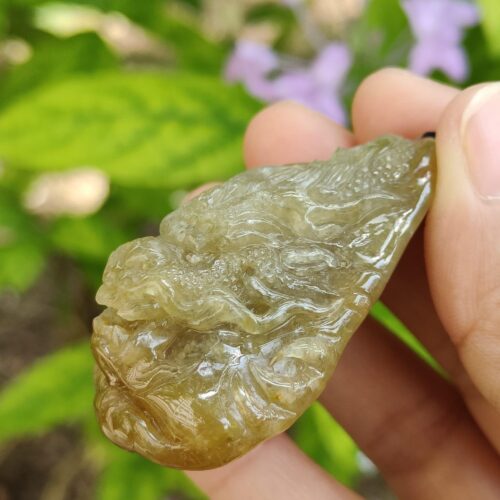 a hand holding a piece of green material