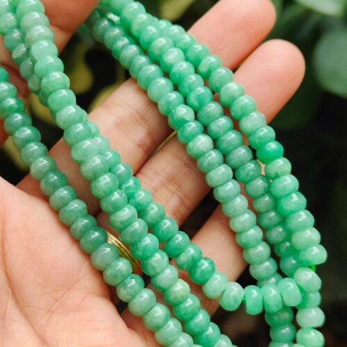 a hand holding a necklace