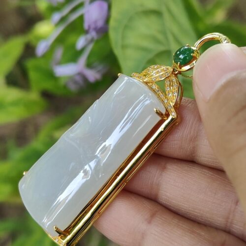 a hand holding a pendant