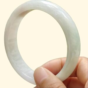 a hand holding a white ring