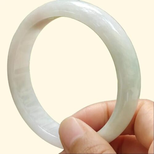 a hand holding a white ring