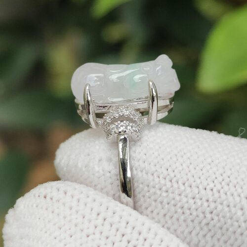 a white ring with a jade stone on it