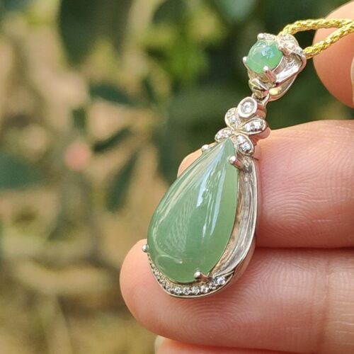 a hand holding a necklace