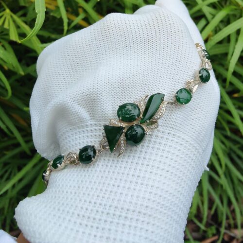 a hand wearing a glove with a bracelet - 10 Dark Green Cabochons