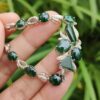 a hand holding a bracelet - 10 Dark Green Cabochons