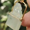 a hand holding a jade pendant - Diamonds setting 18k gold Pixiu