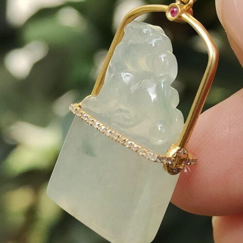 a hand holding a jade pendant - Diamonds setting 18k gold Pixiu