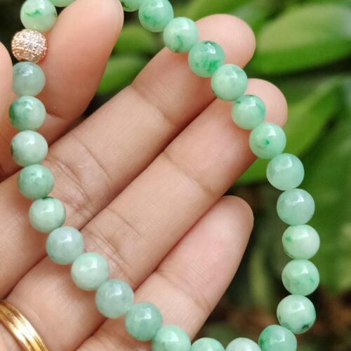 a hand holding a beaded bracelet - Light Green Spicy Green Patches Bracelet