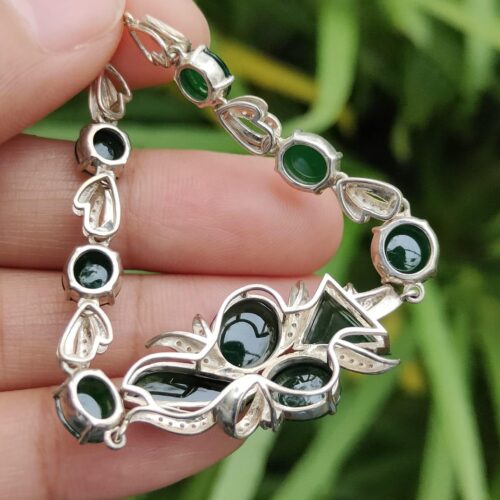 a hand holding a bracelet - 10 Dark Green Cabochons