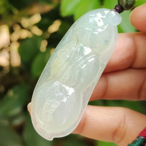 a hand holding a jade necklace - Bean with Bat