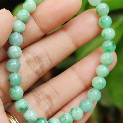 a hand holding a beaded bracelet - Light Green Spicy Green Patches Bracelet