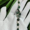 a hand wearing a glove with a bracelet - 10 Dark Green Cabochons