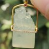 a hand holding a jade pendant - Diamonds setting 18k gold Pixiu