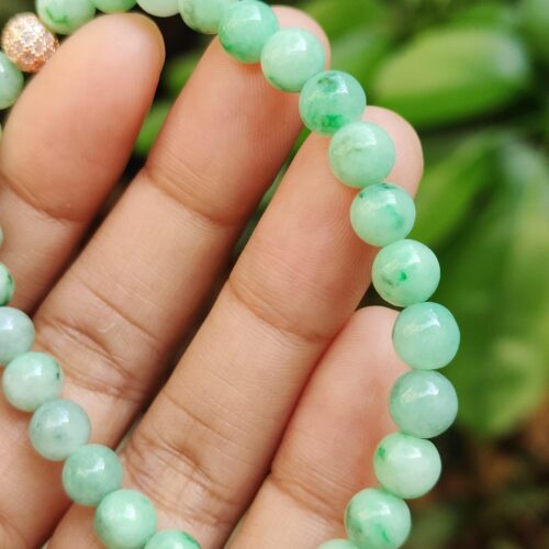 a hand holding a beaded bracelet - Light Green Spicy Green Patches Bracelet