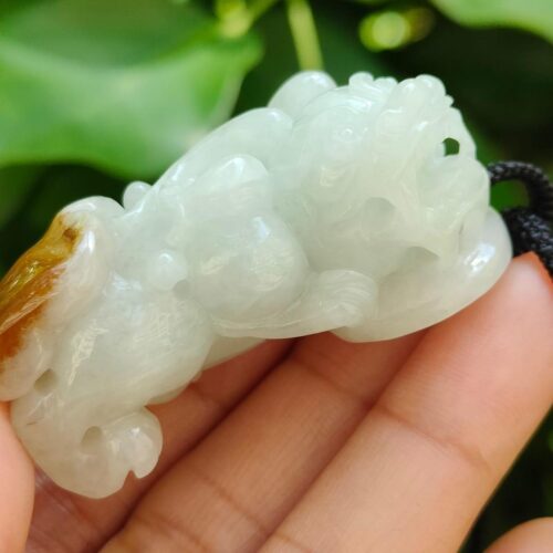 Pixiu wtih light green and yellow skin with reddish brown pendant side view certified YPQ 2025 at meragi park simei hdb area side part with teeth pixiu - 8