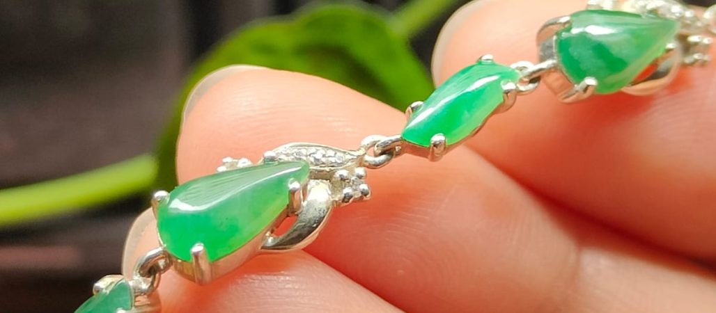 Jadeite Jade Online Store - a hand holding a bracelet - S925 Silver with Green Cabochons